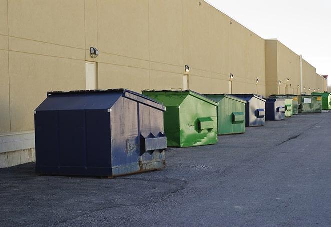 workers clearing construction waste into dumpsters in Alexander AR